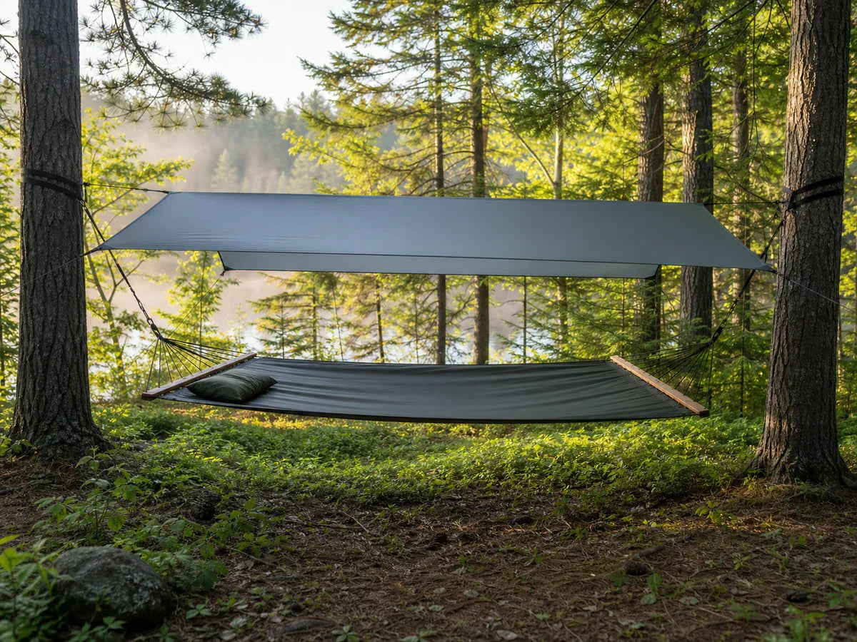Bridge hammock forest campsite hero image with tarp and spreader bars